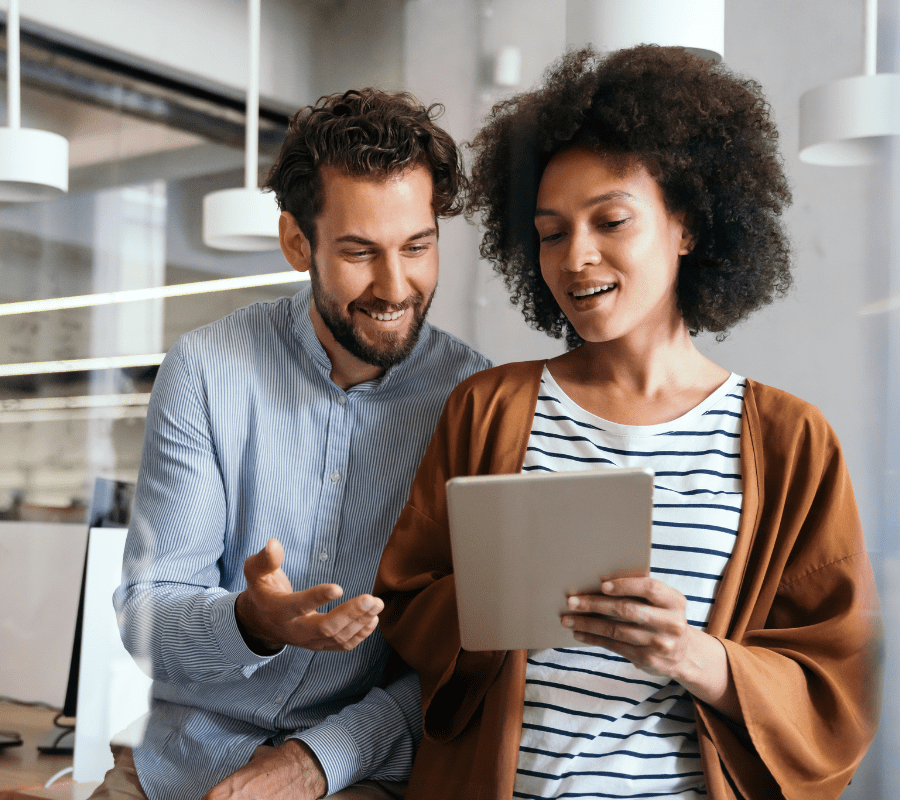 colleagues working over an iPad, indicating collaboration