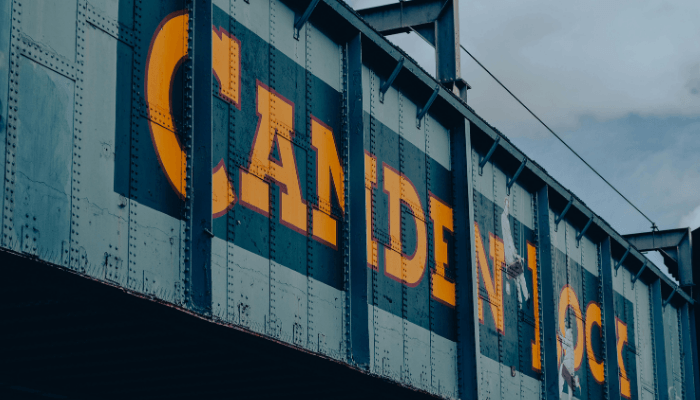 Camden Lock railway bridge signage in London, home to Camden Council's partnership with Matrix on creating local employment opportunities