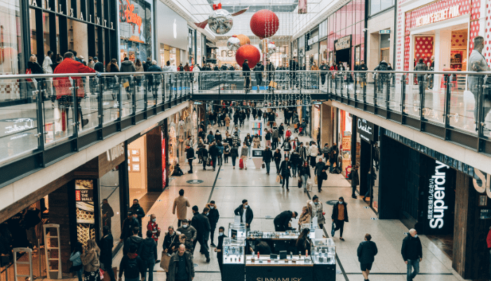 Shopping centre atrium with retail units and customers, reflecting Unibail-Rodamco-Westfield's partnership with Security Watchdog on modernising background screening.