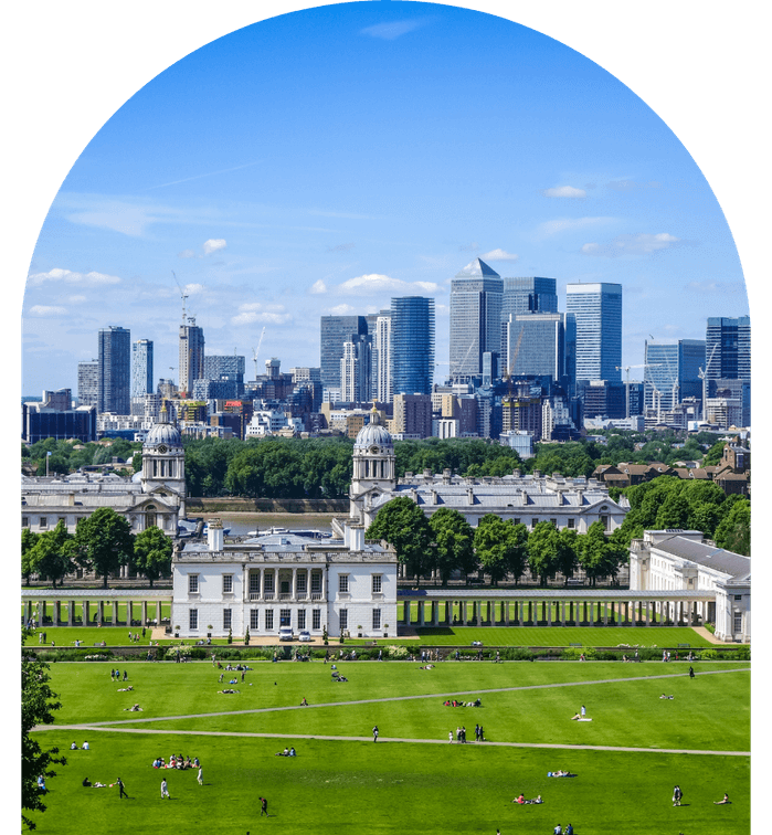 vendor management systems client - Greenwich Park overlooking the historic buildings with skyscrapers of Canary Wharf in the background, under a blue sky.