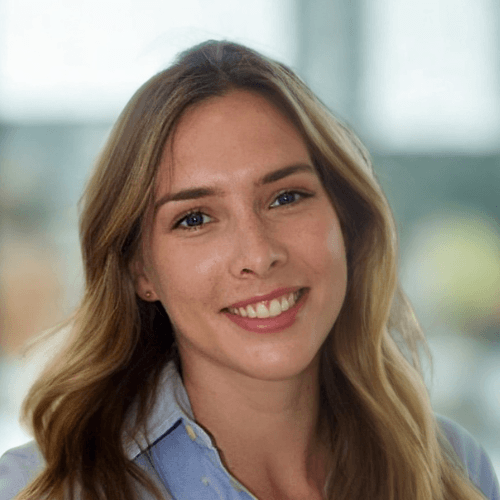 Social Value Workforce - Siobhan Goss, Head of Corporate Social Responsibility for Matrix Workforce, with long hair smiles warmly, wearing a light blue shirt, standing indoors with a blurred background.